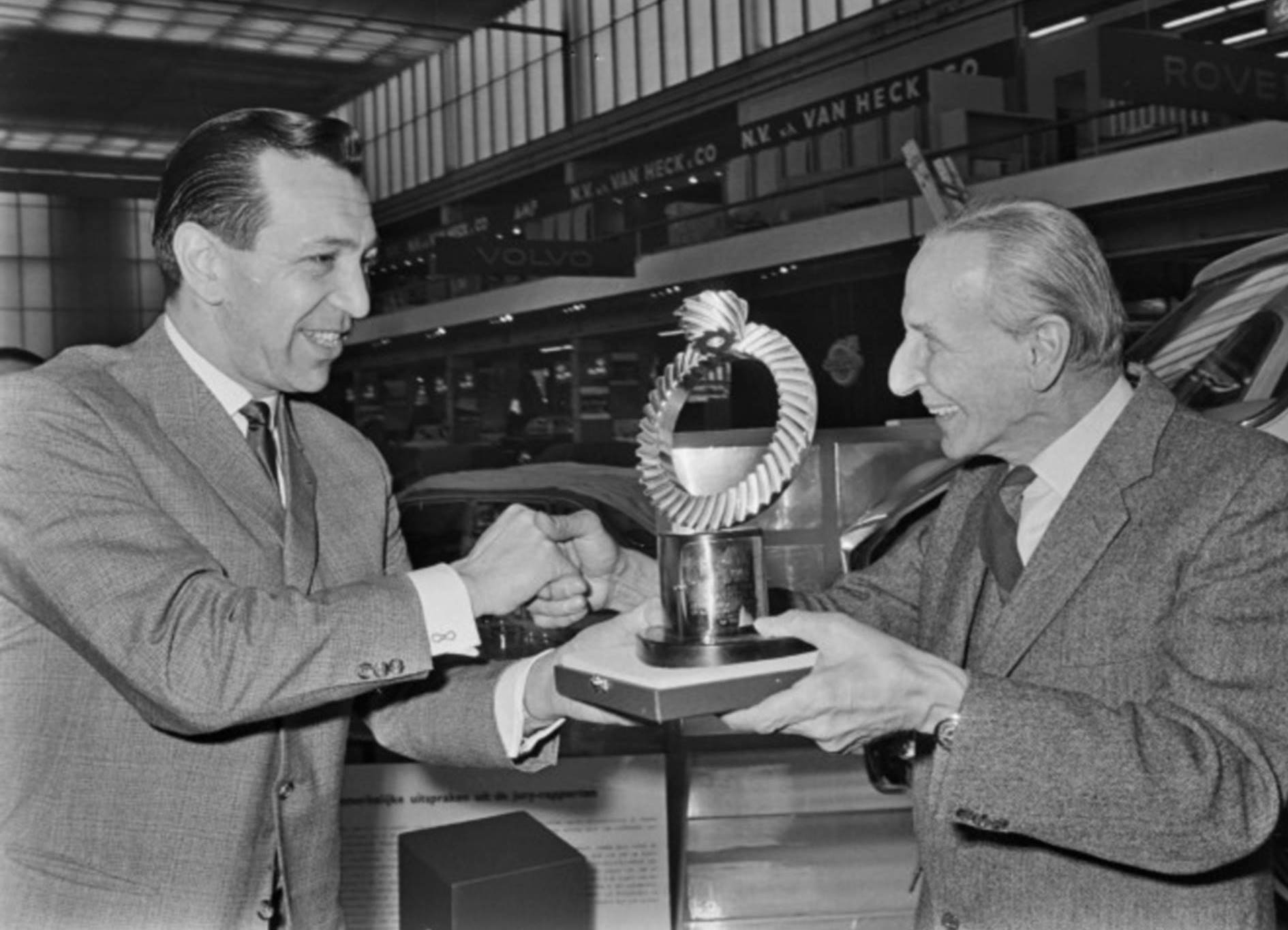 Man hands cup to other man