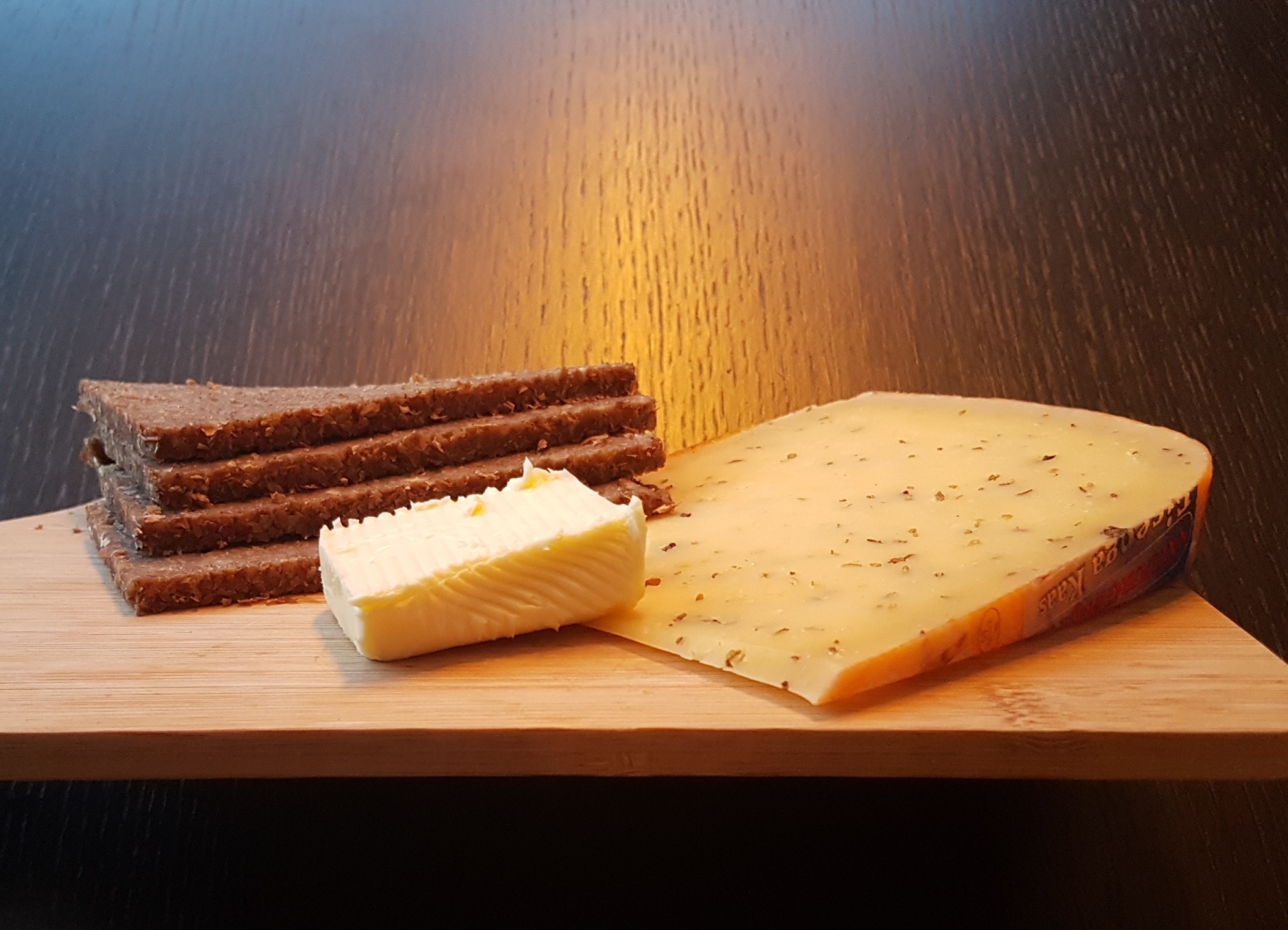 butter, Frisian rye bread and Frisian Clove Cheese on a wooden board