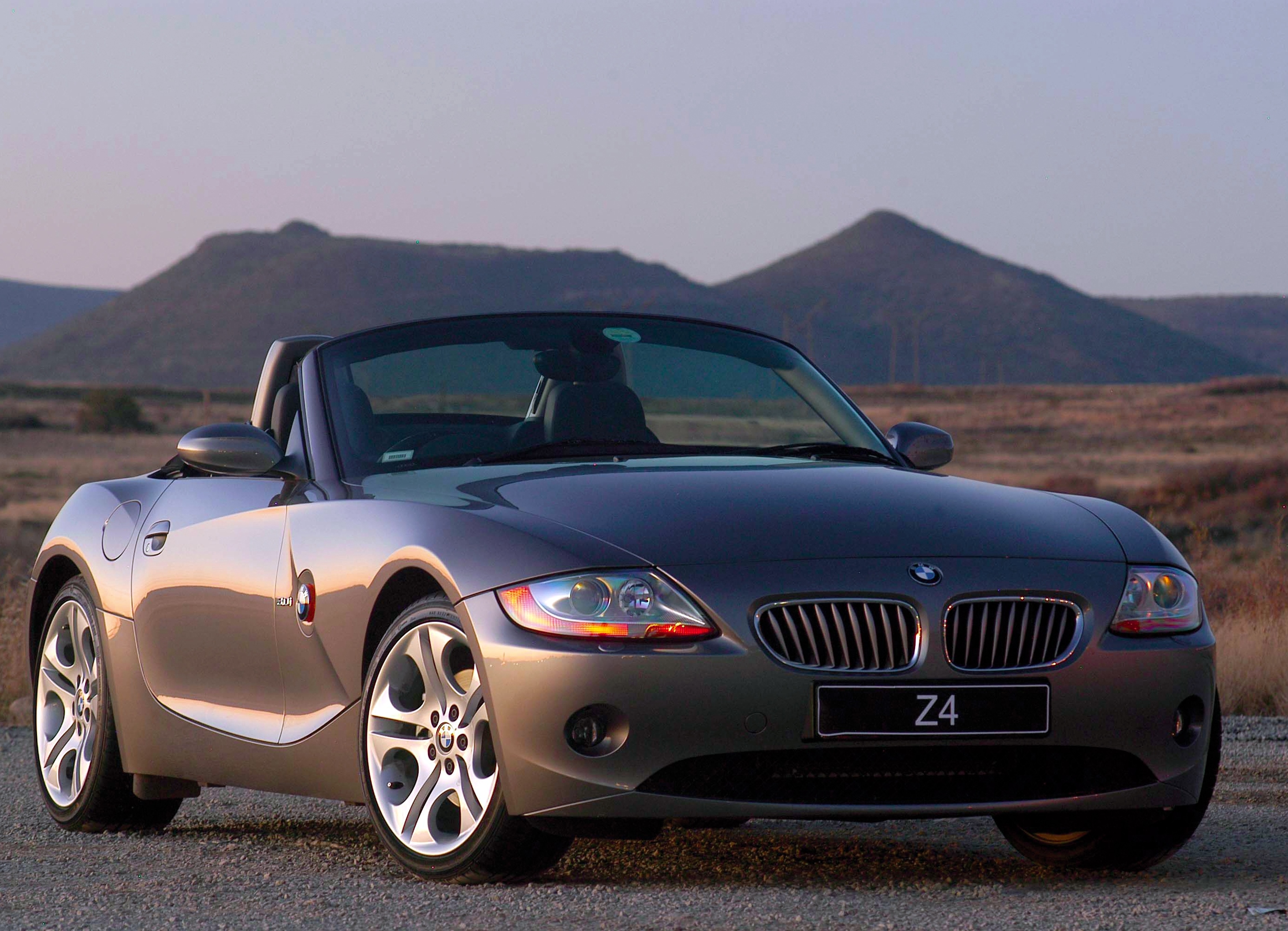 Dark grey roadster with light reflection on the sheet metal.